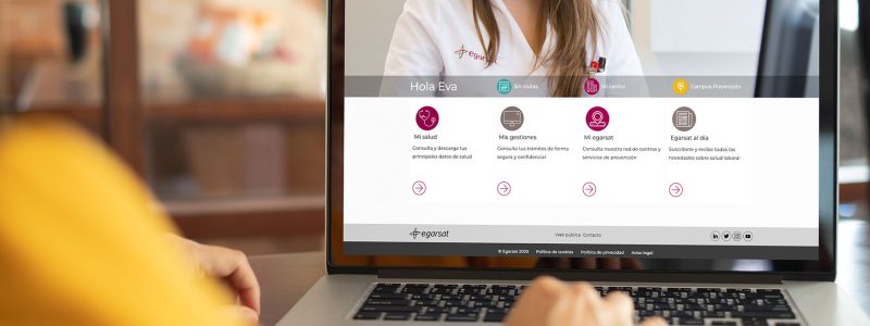 women using laptop computer Mockup image of woman using and typing laptop computer with blank white desktop screen working at home.